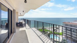 A balcony with a view of the ocean and a pool. - Rare Desirable Unit | Located in Shipps Landing III (Marco Island)