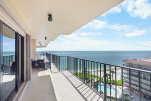 A balcony with a view of the ocean and a pool. - Rare Desirable Unit | Located in Shipps Landing III (Marco Island)