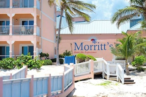 A hotel with a sign reading 'Morritt's Share the Experience,' balconies, and a beachside location.