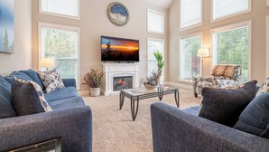 A living room with a fireplace, a television, and a sofa.