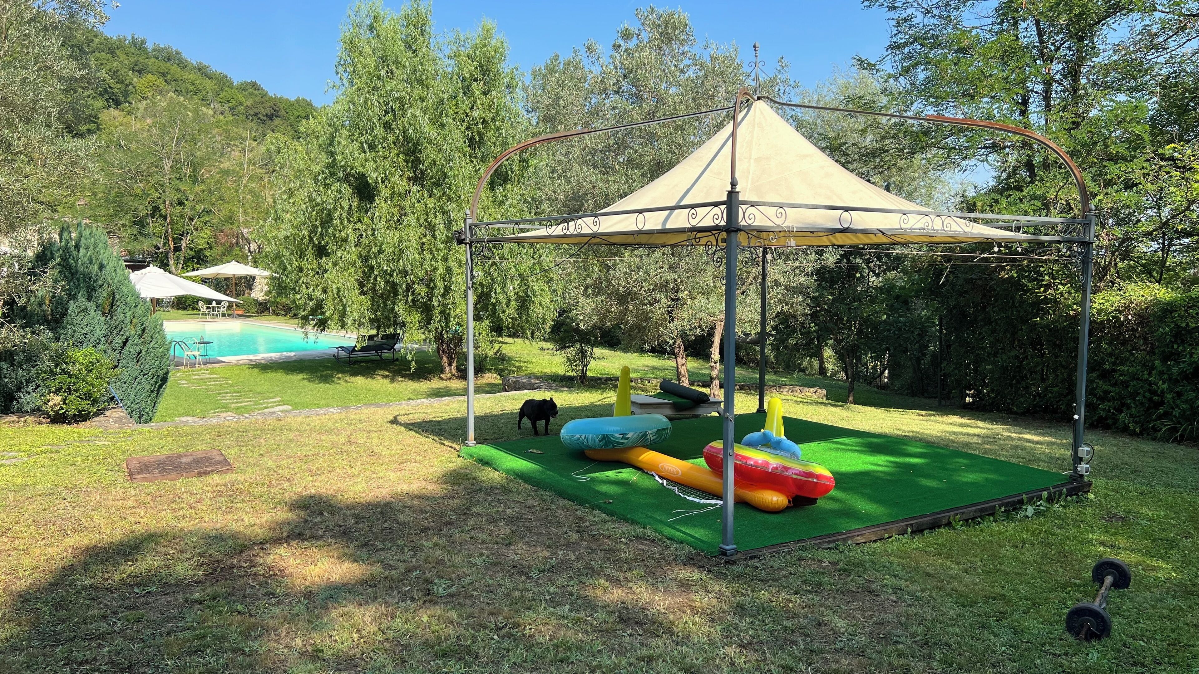 A covered play area with a swing set and soft play equipment.
