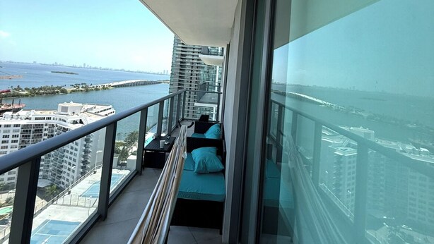 A balcony with a view of a cityscape and water. - Edgawater midtown beautiful 2 bedroom condo available for rent (Miami)