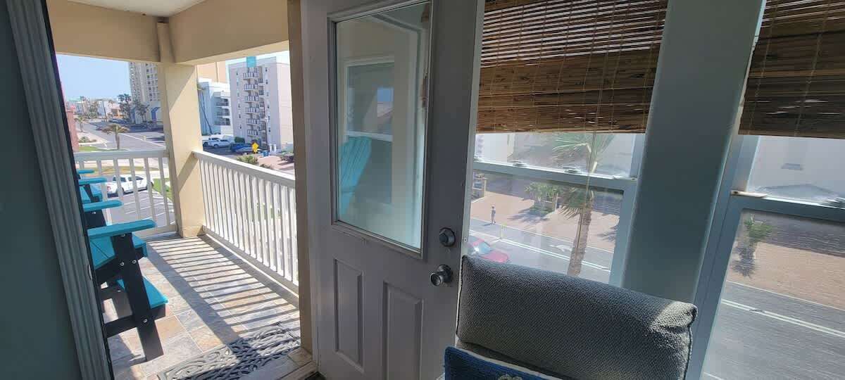A balcony with a view of a street and buildings.
