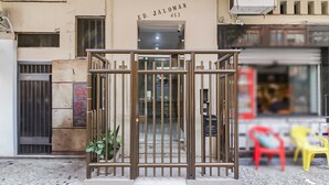 A gated entrance with a metal gate, a potted plant, and a tiled pavement. - 5 minutes from Copacabana Beach | BR902 (Rio de Janeiro)