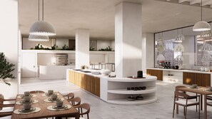 A modern kitchen with a central island, a dining area with wooden furniture, and pendant lighting. - Tinos Beach Hotel (Tinos)