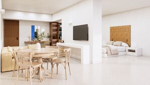 Un saló modern amb zona de menjador, un televisió de pantalla plana penjada a la paret i un espai d'estar acollidor amb un sofà i una taula auxiliar.
