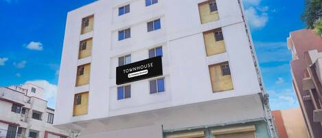 A multi-story building with a sign indicating it is a serviced company property.
