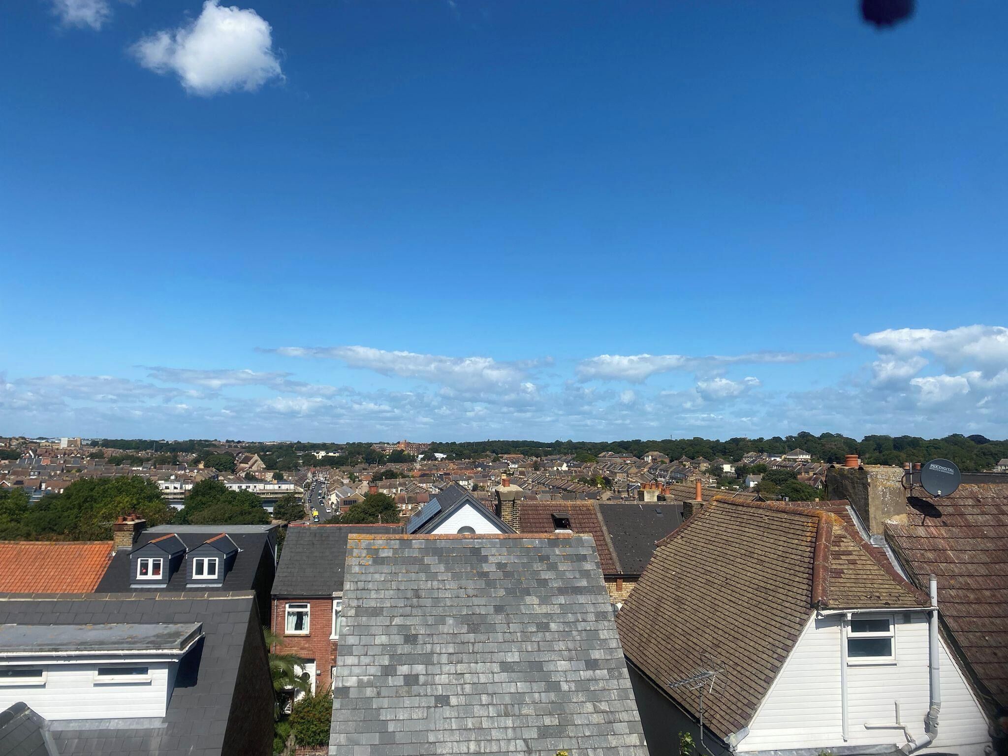 A residential area with multiple houses, some with sloped roofs and others with flat roofs.