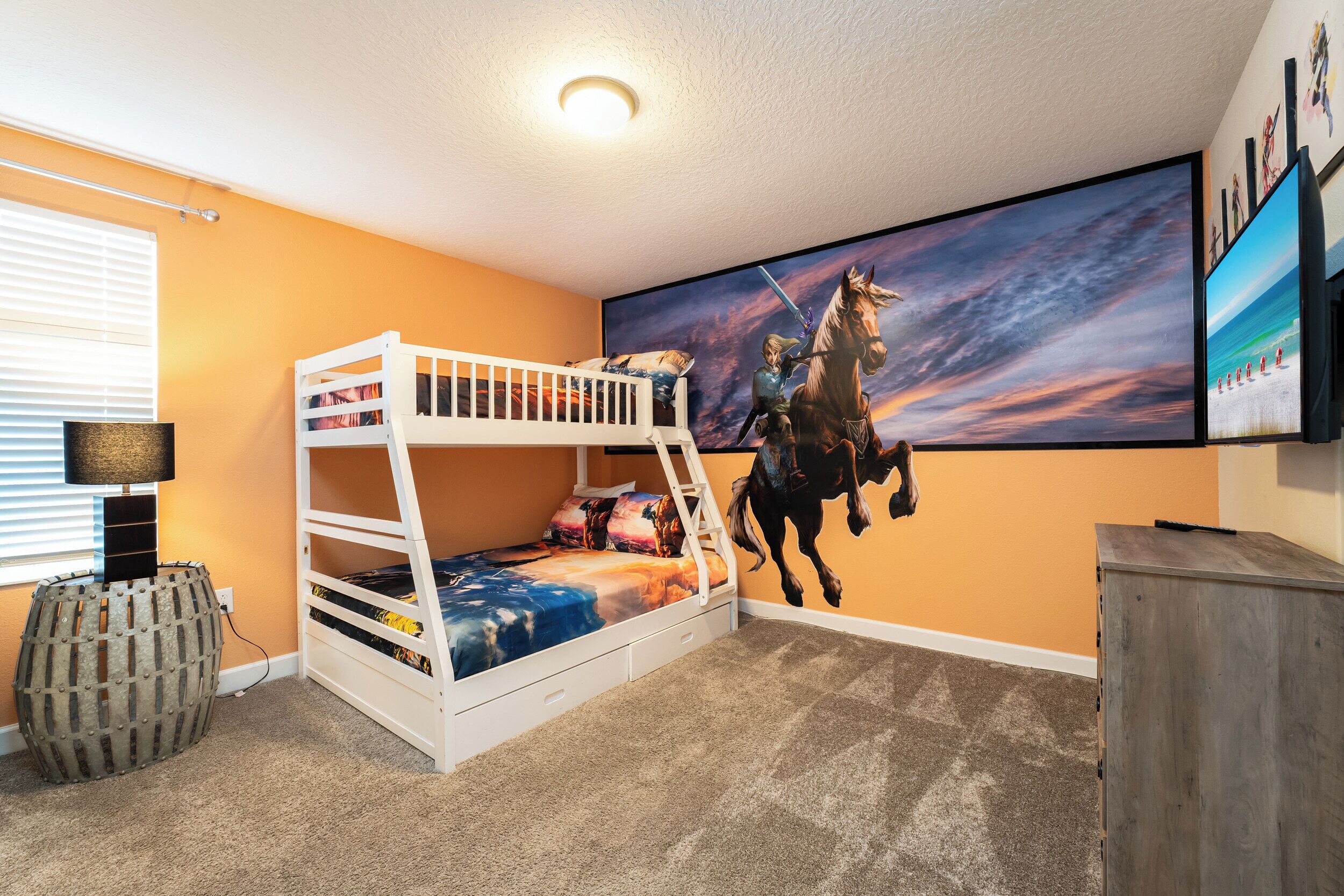 A bunk bed in a room with orange walls, a large painting of a horse and rider, and a wooden cabinet.