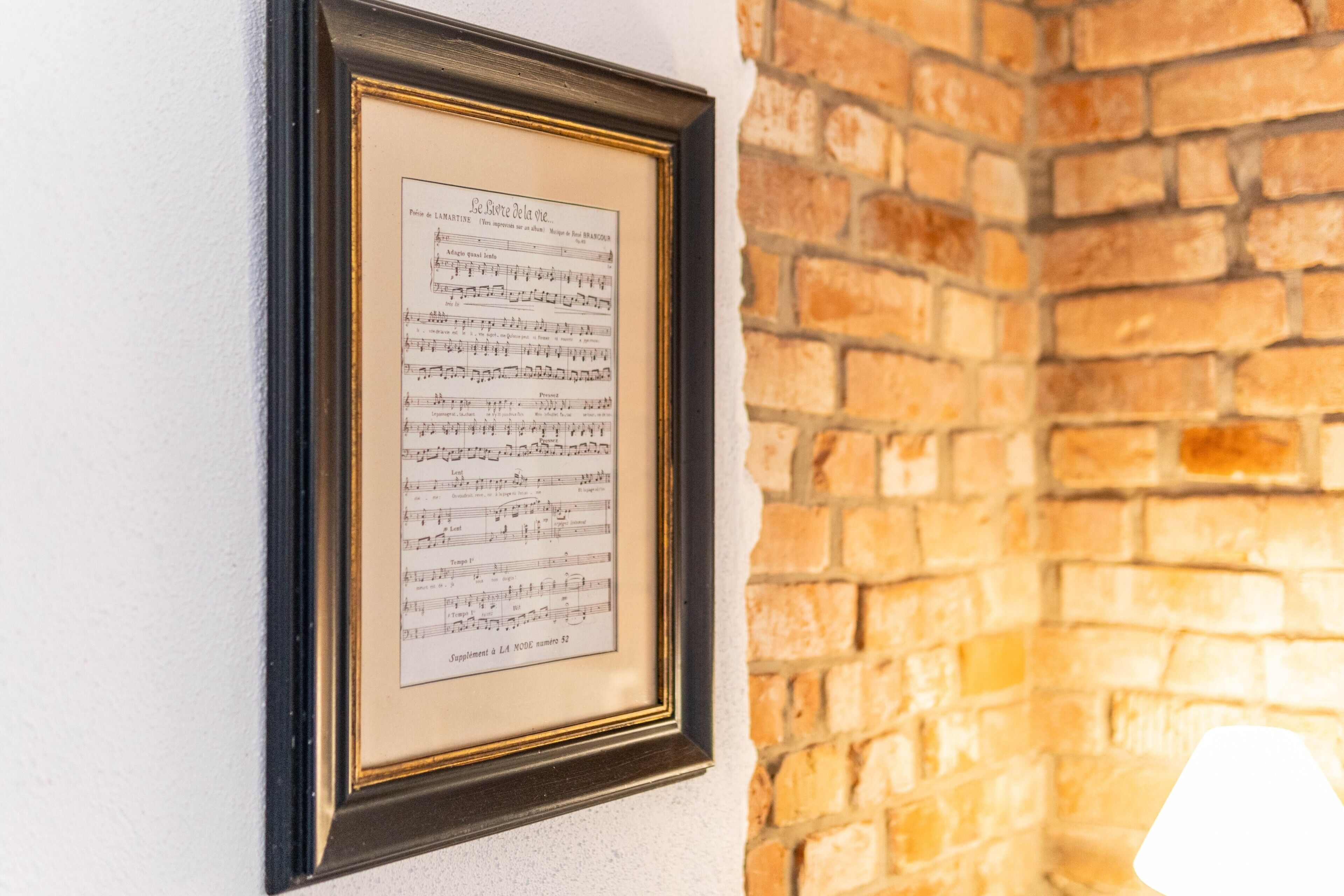 A framed sheet music on a wall.
