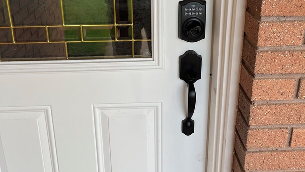 A white door with a glass panel featuring a geometric design.