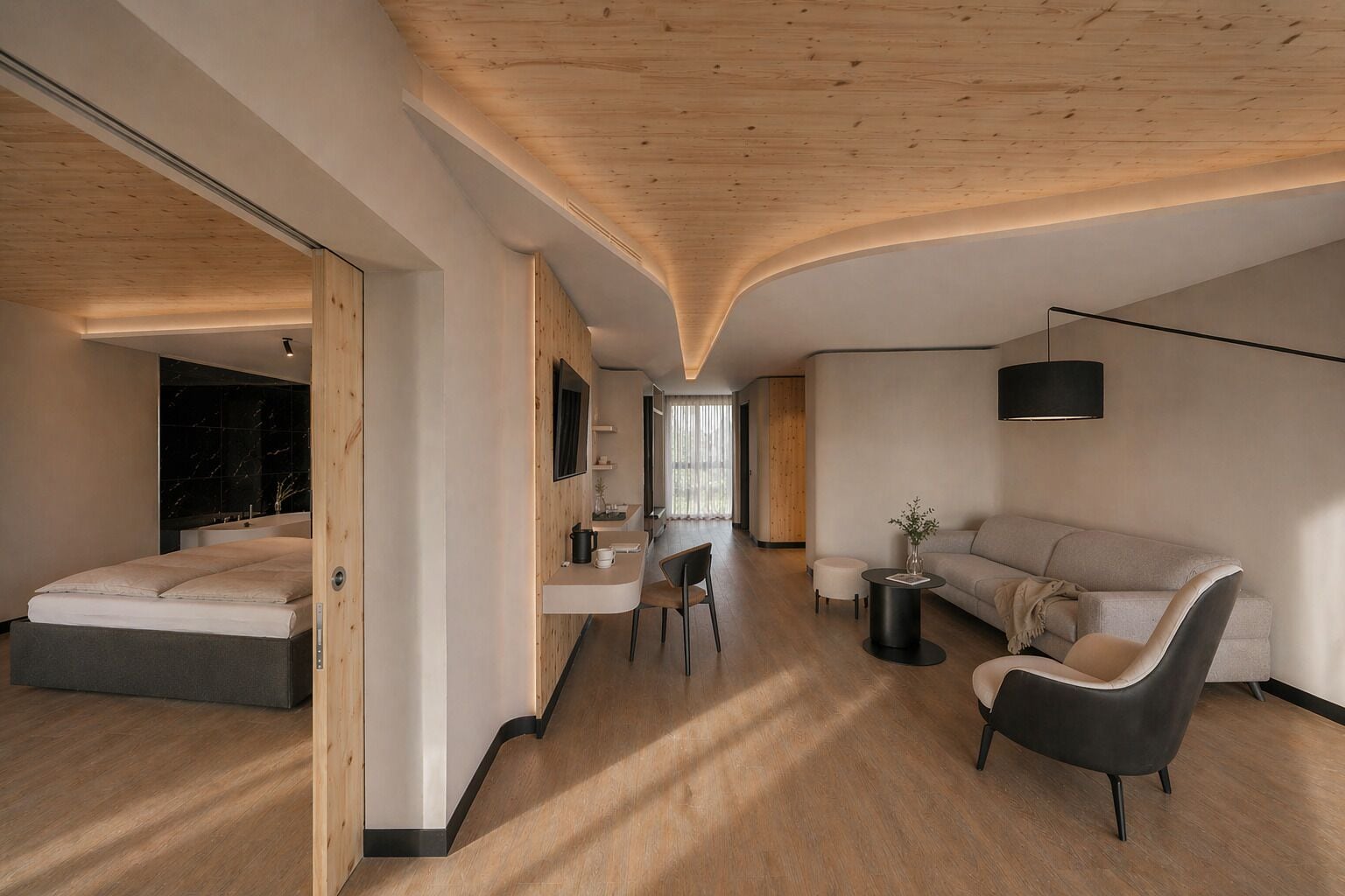 A modern interior with a curved ceiling, a bed, a sofa, a dining area, and a kitchen.