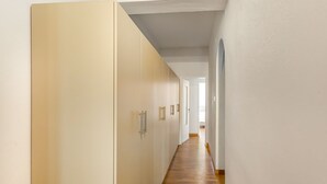 A hallway with wooden flooring, white walls, and a door with a handle. - GuestHost - Roomy and modern apartment of 108 sqm, for up to 7 people, on the 4th floor of a building with lift (NOT suitable for disabled people, some steps to access it). The property is located in the heart of Florence (Restricted-Traffic Area), just  (Florence)