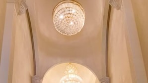 A grand staircase with marble steps and a chandelier. - Anant Palace Hotel (Navi Mumbai)