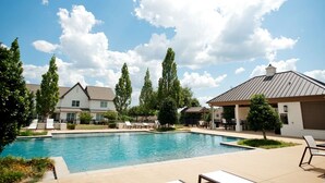 A swimming pool with lounge chairs and a covered patio area. - Stay At The Mill In Oxford (Oxford)