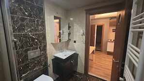 Shower, hair dryer, slippers, towels