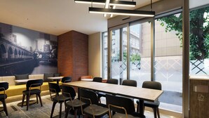 A modern conference room with a long table, chairs, and a mural of a cityscape on the wall. - Four Points Flex By Sheraton Tokyo Higashi Kanda (Tokyo)