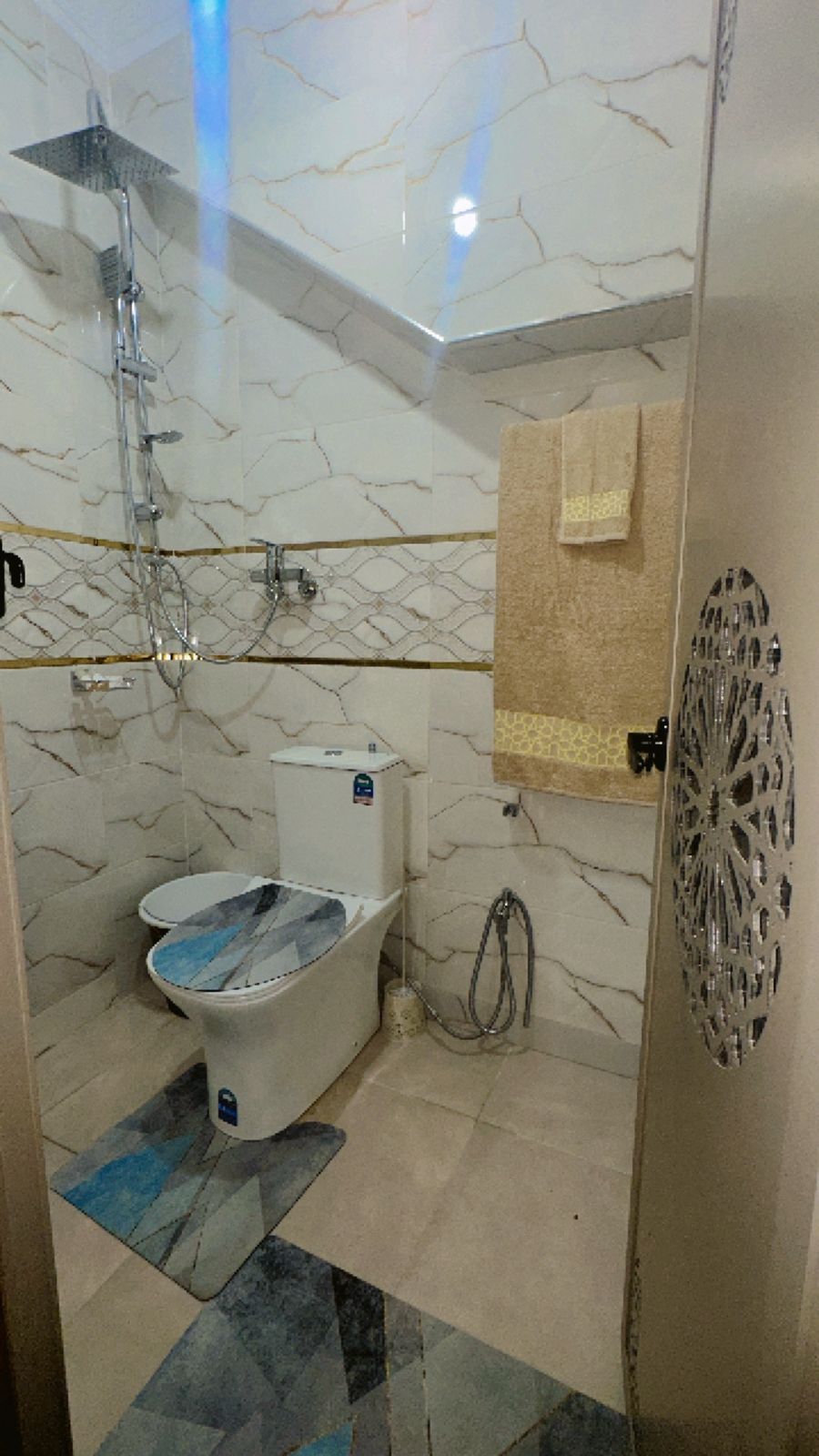 A bathroom with a shower, toilet, and sink.