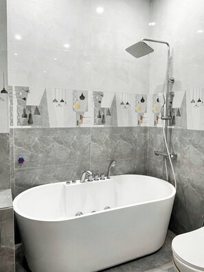 Luxury Double Room, City View | Bathroom | Combined shower/tub, deep soaking tub, hair dryer, slippers