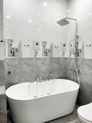 Luxury Double Room, City View | Bathroom | Combined shower/tub, deep soaking tub, hair dryer, slippers