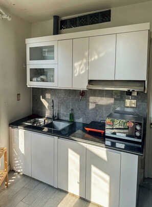 Deluxe Double Room, City View | Private kitchen | Fridge, stovetop, cookware/dishes/utensils, dining tables - KATKA House Hai Phong (Hai Phong)
