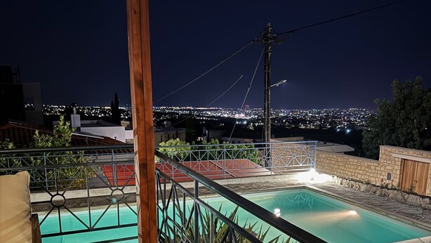A rooftop pool area with a view of the city at night. - 102 PAP - Stay Helios House (Mesa Chorio)