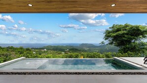 A swimming pool with a view of a mountainous landscape and the ocean. - Mountainside Home with Modern Design, Sweeping Ocean Views & Private Swimming Pool (Tempate)