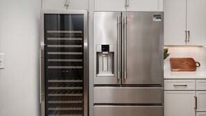 A stainless steel refrigerator with a water dispenser and a built-in wine cooler. - Trinity Beats-private Rooftop Deck-east Nashville (Nashville)