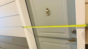 A door with a measuring tape across it, indicating a measurement task. - Cozy 2Bed Boho Hideaway 10 Min to Parks Allows Pet (Bay Lake)
