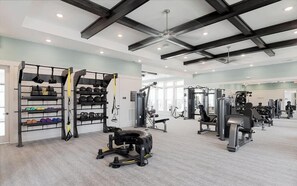 A gym with various exercise equipment, including weight machines and free weights.