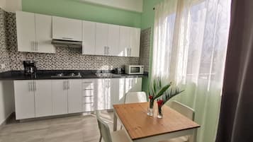 Deluxe Suite, City View | In-room safe, laptop workspace, blackout curtains, iron/ironing board