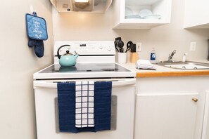 Fridge, stovetop, coffee/tea maker, cookware/dishes/utensils