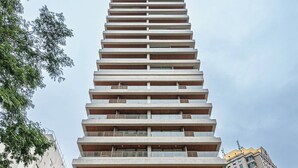 A modern high-rise building with multiple balconies and a store at the ground level. - 360 SP Faria Lima (São Paulo)