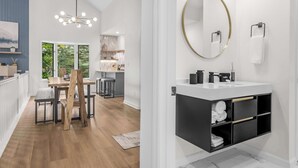 Een moderne keuken met een eethoek, een groot raam en een hanglamp.