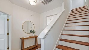 A staircase with wooden steps leading to a landing. - 4BR home with  workspace & parking (Oxford)