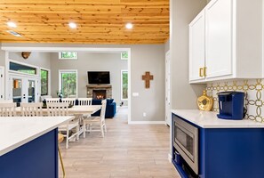 Main level layout featuring open dining, living, and kitchen flow - Kids Play Zones | Hot Tub | 3 Arcades | Family Fun (Broken Bow)