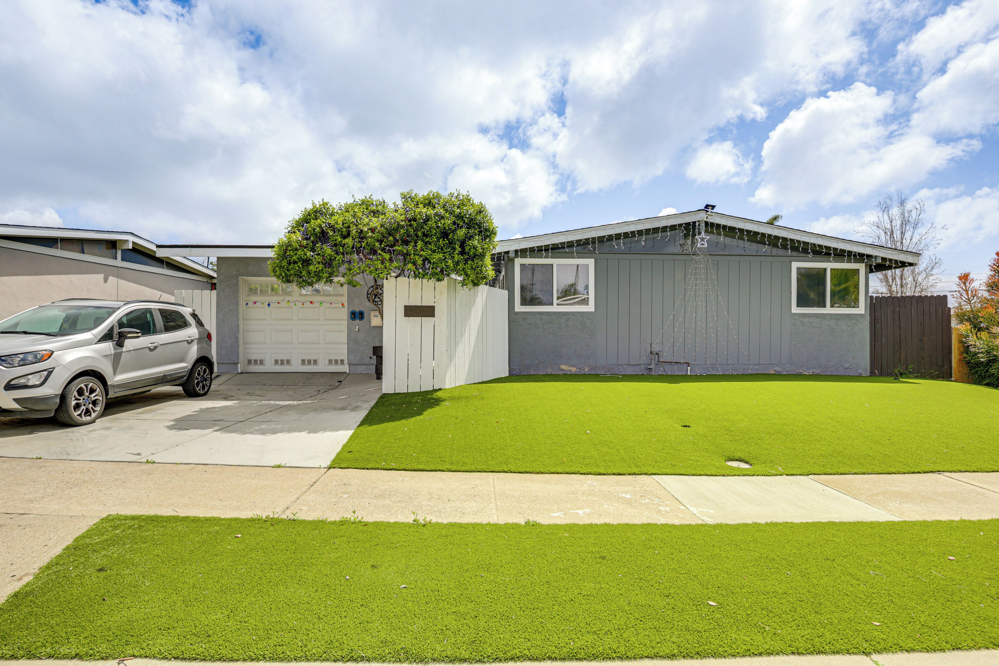 A residential garage with a white SUV parked in front.