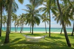 On the beach, white sand, sun loungers, beach umbrellas