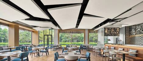 A spacious indoor dining area with high ceilings, large windows, and a modern design.