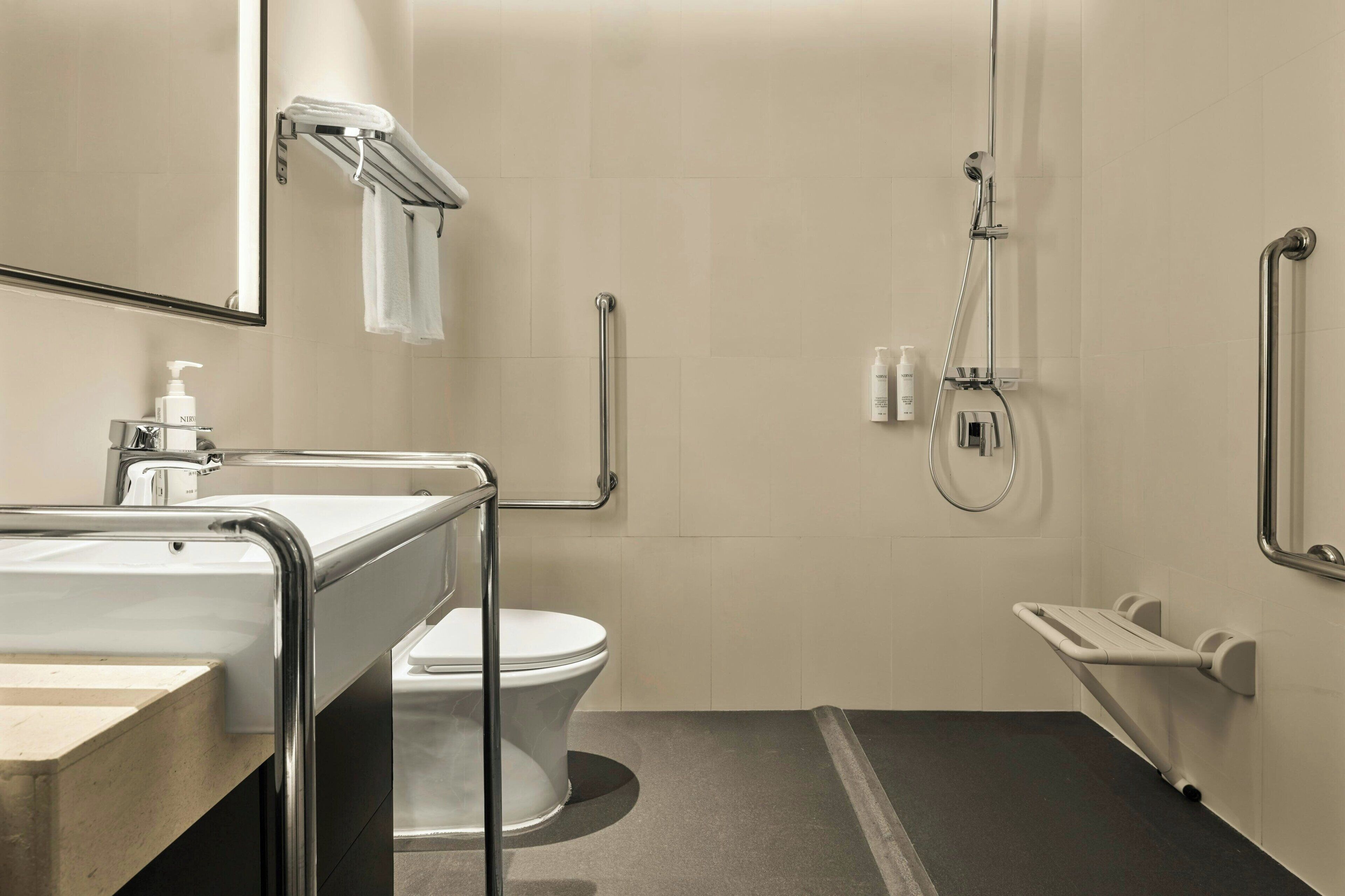 A modern bathroom with a toilet, sink, and shower.