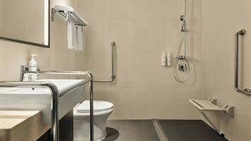 Un baño moderno con inodoro, lavabo y ducha.