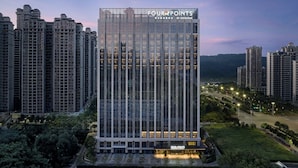 A modern high-rise building with the sign "FOUR POINTS BY SHERATON" at the top. - Four Points By Sheraton Nanning, Wuxiang (Nanning)