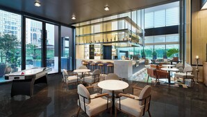 A spacious lobby with a pool table, multiple seating areas, a bar, and large windows offering a view of the outdoors. - Four Points By Sheraton Nanning, Wuxiang (Nanning)