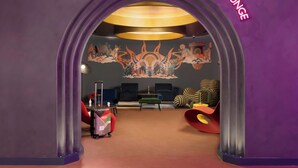 A lounge area with a purple archway, a mural with abstract designs, and modern seating. - Moxy London Piccadilly Circus (London)