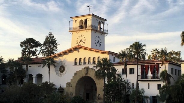 A historic building with a clock tower, arched entrance, and surrounding palm trees. - Montecito Casita Pequena! (Montecito)