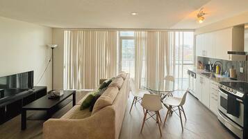 Deluxe Apartment, 1 Bedroom, City View | Living area | 40-inch Smart TV with cable channels