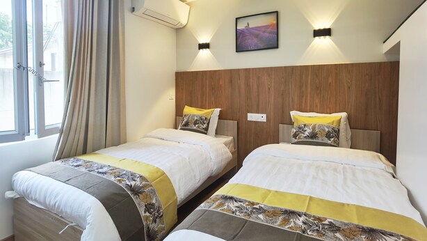 A hotel room with two beds, a window with curtains, an air conditioning unit, and a wall-mounted picture. - New studio with AC / free charging parking（NO.5） (Villemomble)