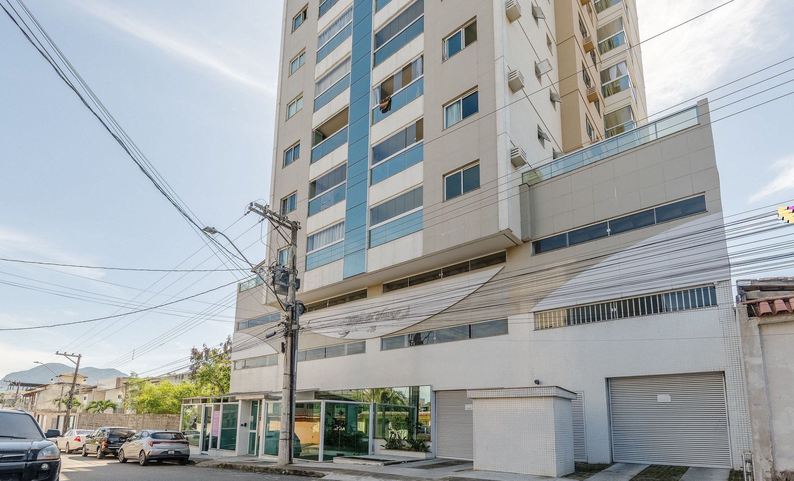 A multi-story building with a modern design, featuring balconies and large windows.