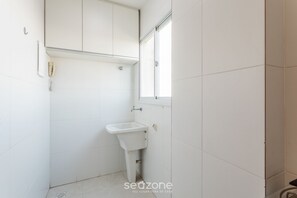 A small, white bathroom with a single sink, a toilet, and a window. - Charming Apt Just 450m From the Beach Emm0202 (Guarapari)