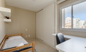 A bedroom with a bed, a desk, and a window with a city view. - Charming Apt Just 450m From the Beach Emm0202 (Guarapari)